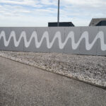 geschnittene Folie auf Mauer verklebt für lange Haltbarkeit im Außenbereich